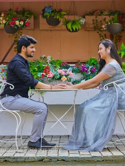 A romantic hand-hold across the table at our European-style cafe set, surrounded by flowers for a charming and intimate portrait.