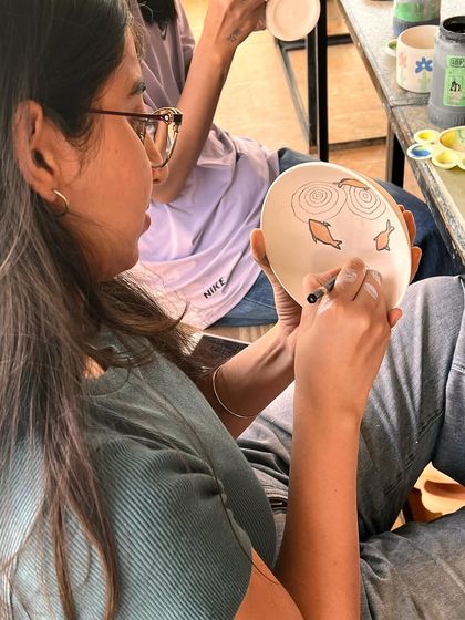 A proud moment watching one of my students paint her own beautiful design onto a bowl during a workshop.
