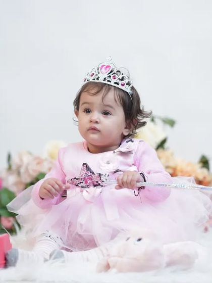 Every little girl is a princess. This sweet studio portrait features a princess dress, a tiara, and a magic wand for a truly enchanting photo.