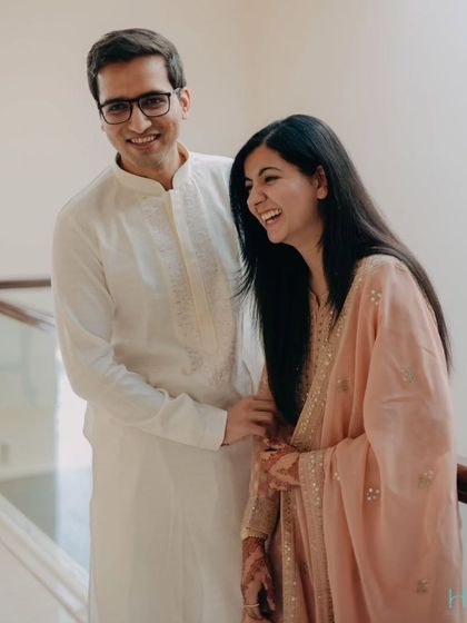 Laughter and love on a simple staircase. The couple's relaxed and happy demeanor shines in this candid shot, proving that the best photos happen when you're just being yourselves.