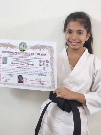 A happy and proud Lekissha, showcasing her Degree Certificate from the International Indo-Ryu Karate-Do Federation. This is a moment she will cherish for a lifetime.