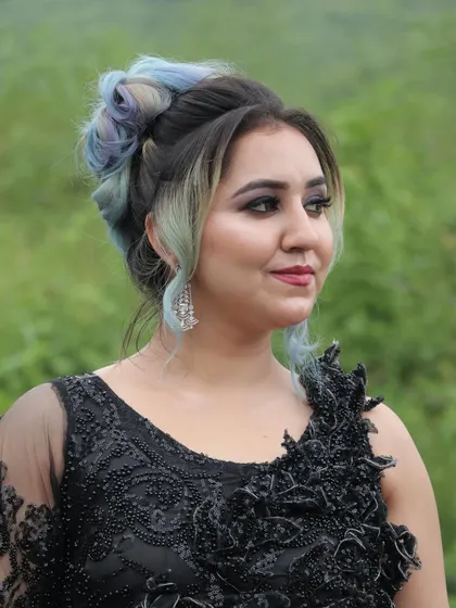Our training covers modern glamour and hairstyling too. This look, created by a student, features a soft glam makeup with a trendy, colorful hair updo, perfect for fashion shoots and events.