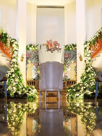 A grand staircase decorated with waterfalls of white flowers. I utilize the existing architecture of a venue and enhance it with opulent floral designs to create dramatic and luxurious settings.