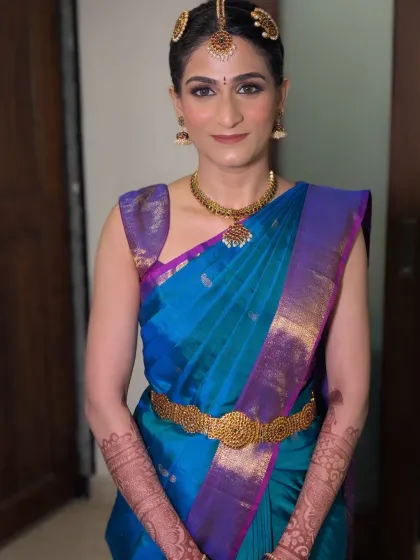 My modern Tamil bride Shriya, looking absolutely chic. I created a natural, glowing makeup look and draped her beautiful blue pattu saree to perfection, ensuring she felt comfortable and radiant.