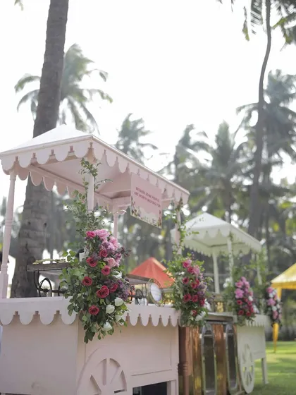 Charming food carts are a perfect addition to any wedding carnival. I designed these pink carts with floral arrangements to serve treats to guests, adding to the festive and interactive atmosphere.
