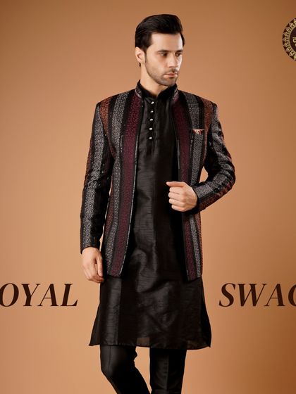 Royal swag. This black Indo-Western jacket with maroon and silver stripes is paired with a black kurta set for a layered, sophisticated look.