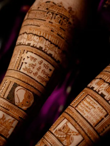 Another view of the forearm with personalized panels. Here you can see a beloved pet's face and a special verse, making the bridal mehendi a true reflection of the bride's life.