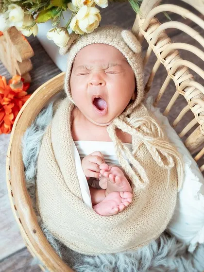 A perfectly timed yawn! Newborn sessions are relaxed, and we work around your baby's schedule, capturing everything from deep sleep to little yawns and stretches.
