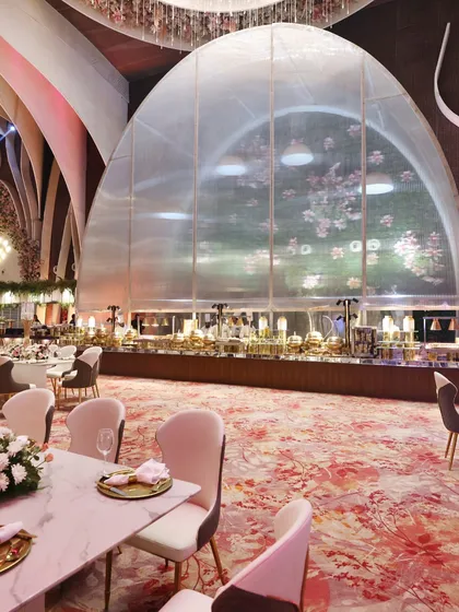 A grand, light-filled hall with soaring arches and elegant table settings. This is the canvas upon which we paint our culinary masterpieces.
