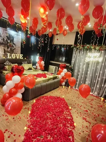 A wide-angle view of our ultimate romantic room setup, showing the rose petal pathway, balloon-filled room, and glowing "Happy Birthday" sign.