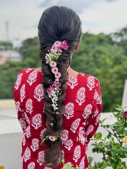 The full length of the floral fishtail braid, a perfect hairstyle for a mehendi or outdoor sangeet ceremony.