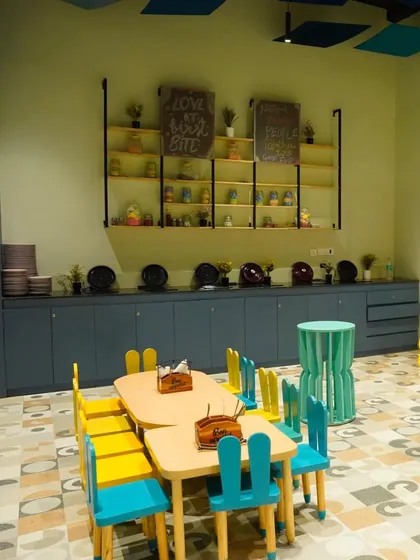 A look at our food and beverage counter area, with kid-friendly tables in the foreground. We ensure every part of our facility is clean and well-maintained.