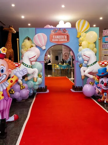We create grand, immersive entrances that set the tone for your party from the moment guests arrive. This carnival-themed entrance features a red carpet, character cutouts, and classic circus decor.