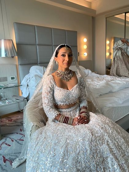 The bride, ready and waiting. Her sleek bun ensures she looks polished and photo ready from every angle, even in candid moments before the ceremony.