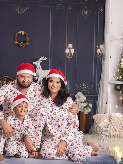 This happy family in matching pajamas is all set for a cozy Christmas morning, posing together in our festive studio.