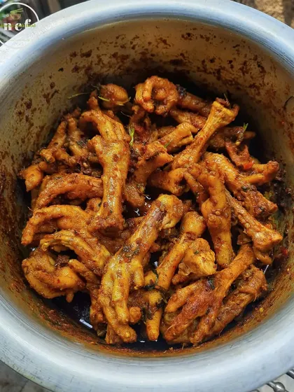 A bowl of chicken feet stir-fry, a savory and popular snack in Manipur.