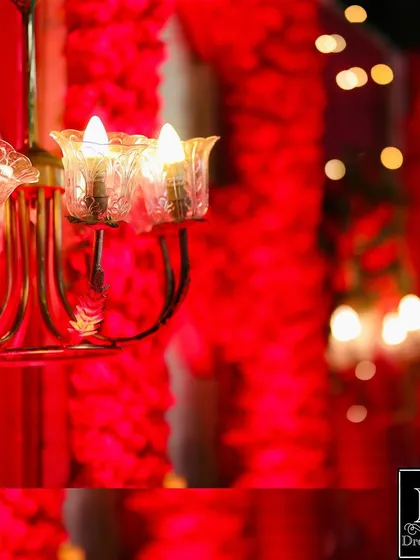 A close-up detail of the red wedding stage. I incorporated small chandeliers within the floral wall to add a warm, ambient glow to the decor.