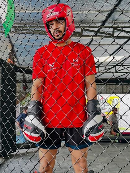 A fighter stands ready in the cage, focused and prepared for his match. This is the culmination of countless hours of training.