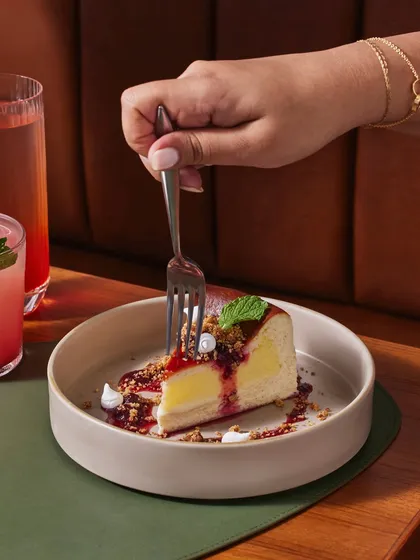 A moment of pure indulgence. Our Burnt Basque Vanilla Bean Cheesecake, with its bright lemon curd insert and oatmeal crumble, is a dessert that tells a story of texture and nostalgia.