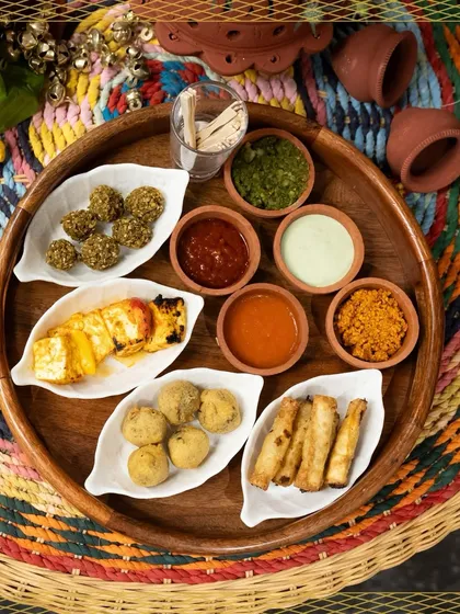 A platter that brings your street food dreams to life. It features an assortment of our popular snacks like paneer tikka, kachoris, and cigar rolls, complete with a variety of flavourful chutneys.