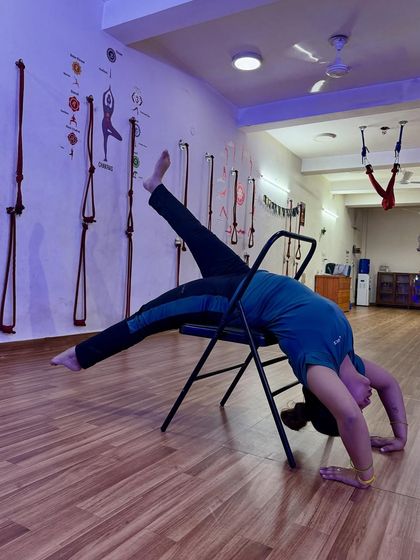 Adding a leg lift to a chair backbend for an extra challenge to the core and hip flexors.
