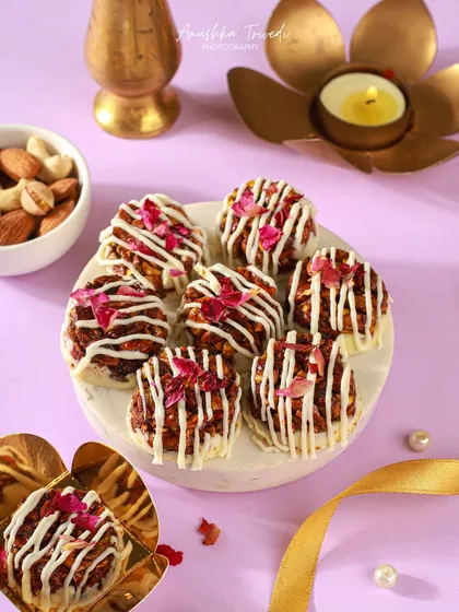 A platter of the mini rose and white chocolate desserts, styled with a golden ribbon. The composition is elegant and perfect for a celebration.