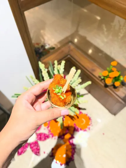 A single, perfectly crispy arancini ball held in hand, showcasing the golden-brown texture. This is our Mushroom & Truffle Arancini, a popular choice for passed appetizers at parties.