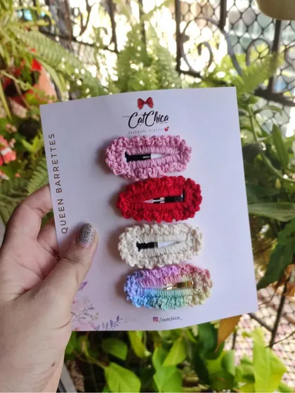 Holding a set of four 'Queen Barrettes' in my hand. The size is perfect for holding back bangs or decorating a ponytail.