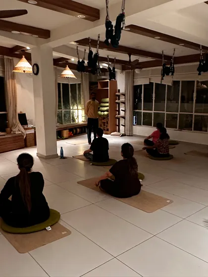 An evening class in progress. My role as a guide is to hold the space for students to explore their own practice, offering instruction and support as they move and breathe.