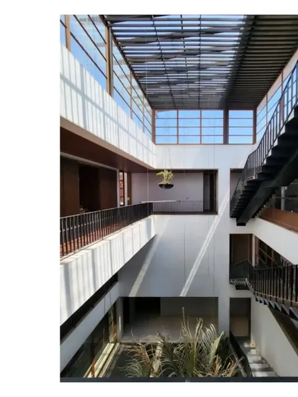 The interior of our 'Ishtika' project, showing the triple-height volume and the play of light through the perforated roof.