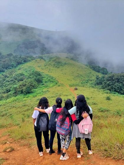 Friends trekking together on the misty trails of Kodachadri. Our trips are a great way to bond.