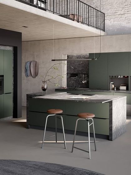 A bold kitchen design in a deep green, paired with a textured concrete-look island. This shows how we can play with color and texture to create a unique statement.