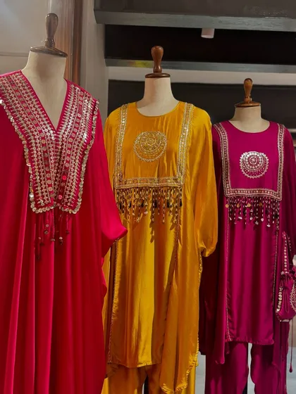 Another view of the Prahnaaya tunics, showcasing their vibrant colors and festive embellishments.