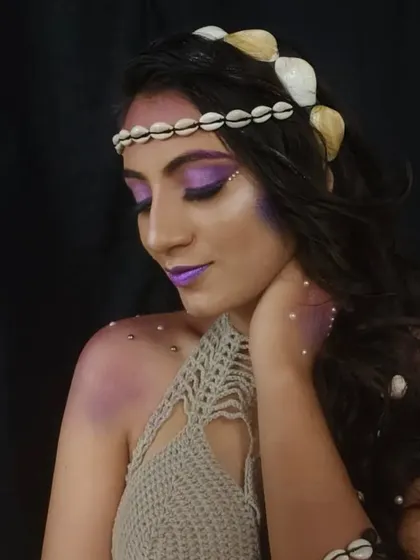 A serene pose capturing the full mermaid fantasy. The seashell headband and crocheted top complete the mystical, sea-inspired character design.