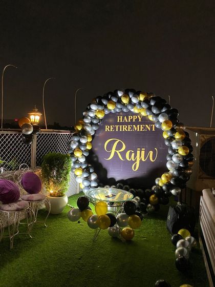 A wide shot of the rooftop retirement party, showing the seating arrangement.