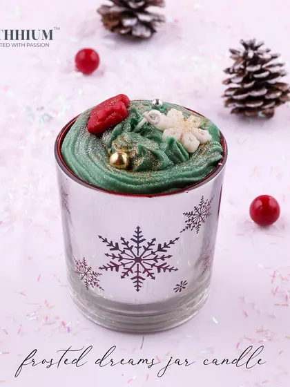 A 'Frosted Dreams' jar with a snowflake design and green whipped wax.