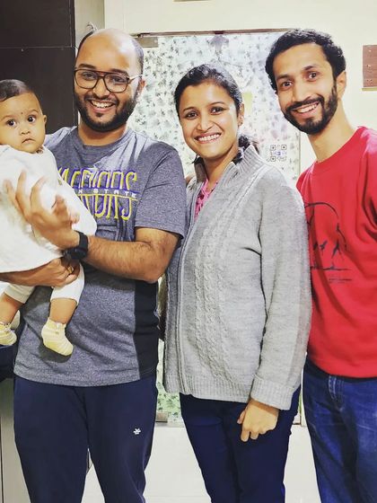 A group photo celebrating the new arrival. We build strong relationships with our students, and it is an honor to be part of their family's wellness journey from pregnancy to post-delivery.