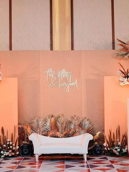 The main stage for a chic engagement party. We used a palette of peach and blush tones with arches of dried pampas grass and palms to create a backdrop that was modern, romantic, and sophisticated.
