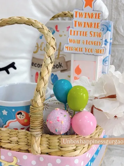 This angle shows the "Twinkle Twinkle Little Star" card and other decorative elements that make this moon-themed hamper a magical gift for expecting parents.