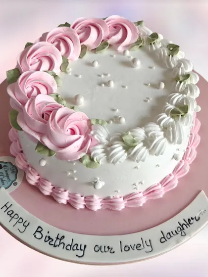 A simple and classic floral cake with pink rosettes. This timeless design is perfect for any daughter's birthday.