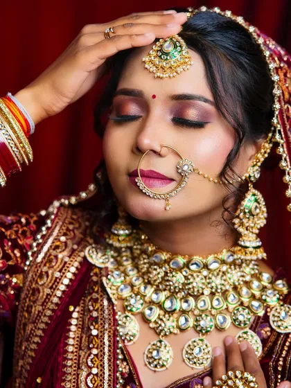 A beautiful close-up of a bridal look, focusing on the warm-toned eyeshadow and the intricate kundan jewelry. This is a result of dedicated practice in our studio.