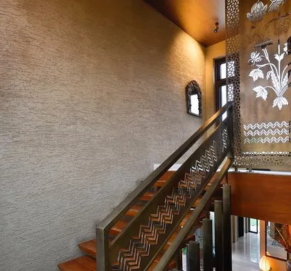Detail is a language we speak fluently. For this staircase in a New Delhi farmhouse, we drew inspiration from traditional Sanjhi paper-cutting art to create a laser-cut metal screen. It acts as a delicate, light-filtering veil, demonstrating our approach of reinterpreting heritage crafts with modern fabrication techniques.