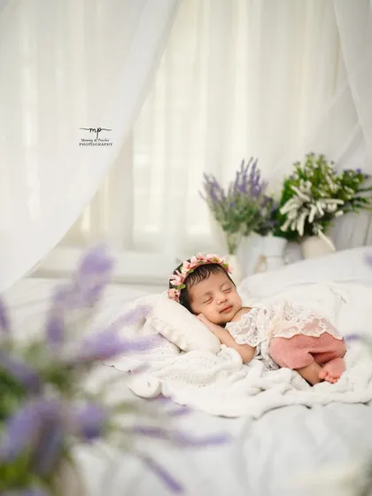 A sweet sleeping baby, smiling in her dreams. I aim to capture these fleeting, precious moments of pure peace during our newborn sessions.