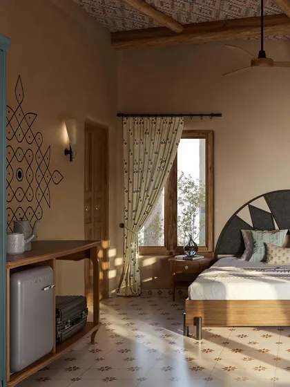 Sunlight streams into the room, casting beautiful shadows and highlighting the hand-painted *kolam* and the texture of the mud walls. This space is designed to feel bright, airy, and deeply calming.