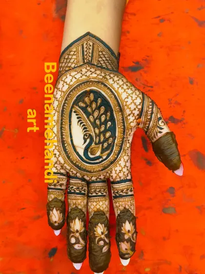 A stunning design with a majestic peacock as the centerpiece on the palm. The fingers are decorated with lotus motifs, completing the traditional look.