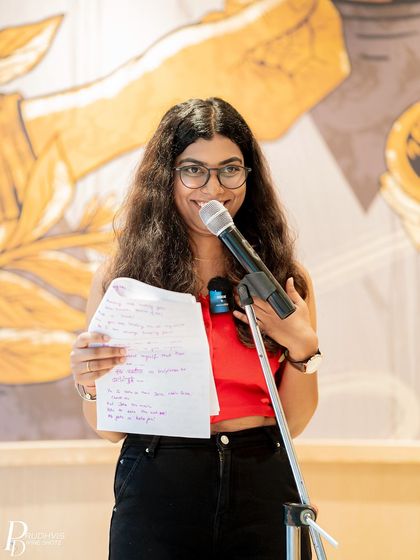 A young poet shares her handwritten poem. The theme "Voices of the Nation" brought out a rich tapestry of voices.