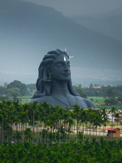 The Adiyogi statue with the Velliangiri hills in the background, a powerful symbol of spirituality nestled in nature.