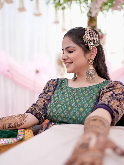 A candid shot of a beautiful bride during her mehandi ceremony, her hands adorned with the story of her new beginning.