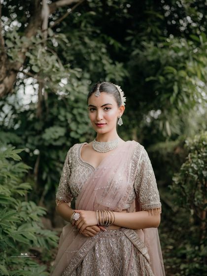 A classic and elegant portrait. The bride's direct gaze and poised stance exude confidence and grace.