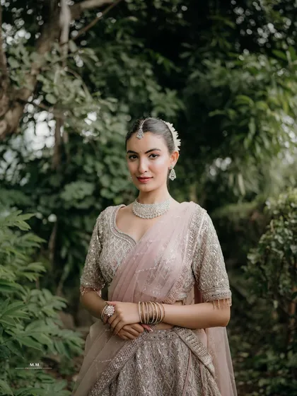 A classic bridal portrait. The bride's elegant pose and the soft, natural background create a timeless and graceful image.